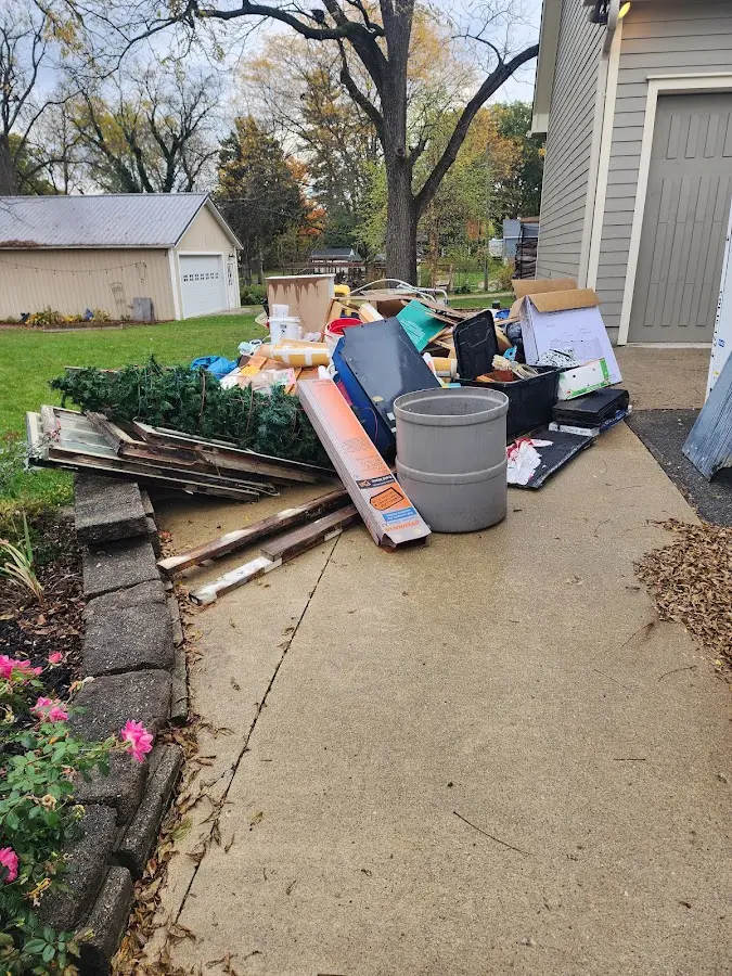 Dumpster being loaded with debris for Roofing Dumpster Rental in Hunters Creek